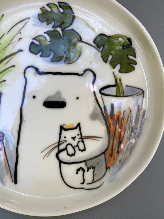 Bear with his cat and plants