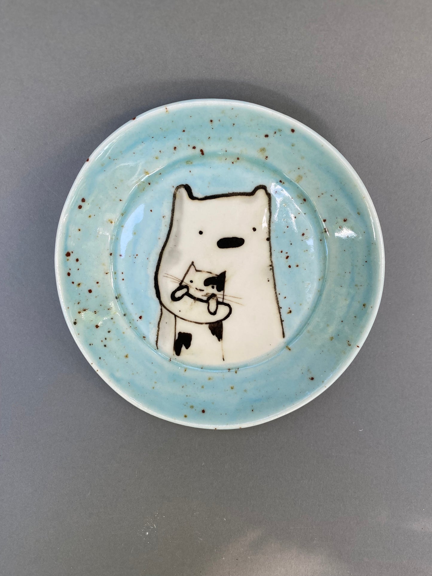 Bear holding a cat