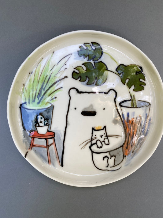 Bear with his cat and plants