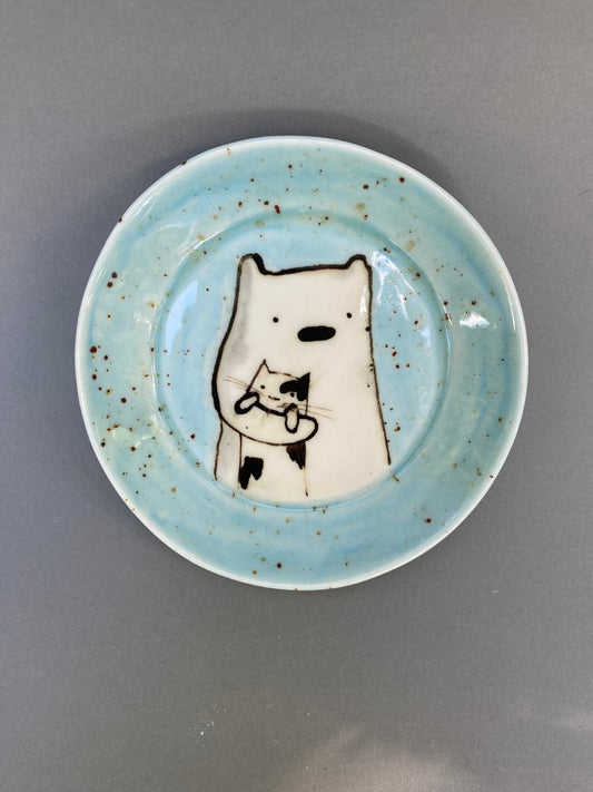 Bear holding a cat