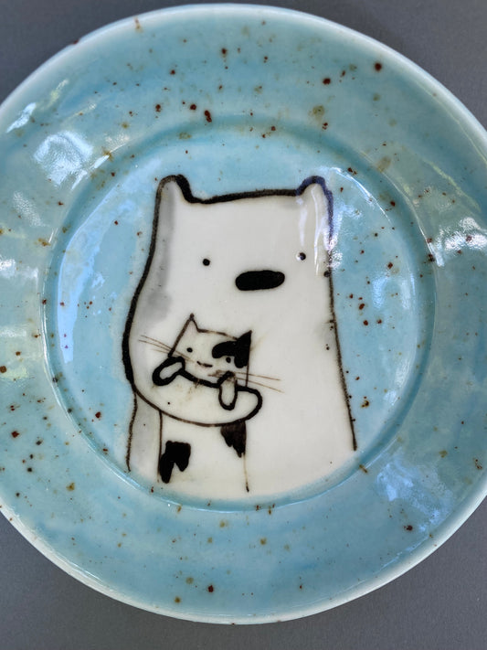 Bear holding a cat